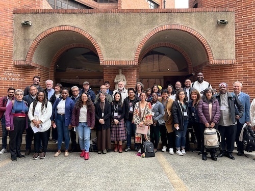 Group photo of conference participants outside of the Capilla San Ignacio at Javeriana University in Bogotá, Colombia.