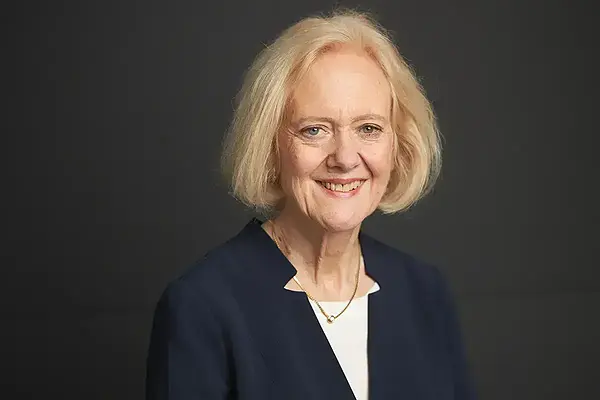 Boston College Professor Lisa Sowle Cahill with blonde hair and heterochromia (one blue, one green eye) smiles warmly.
